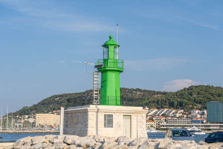 Split, Croatia - Aug 15, 2020: Green lighthouse at old port in early morningのeditorial素材