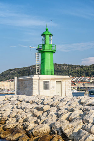 Split, Croatia - Aug 15, 2020: Green lighthouse at old port in early morningのeditorial素材