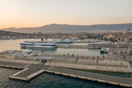 Split, Croatia - Aug 13, 2020: Aerial drone shot of ferry cruise port during sunset hourのeditorial素材