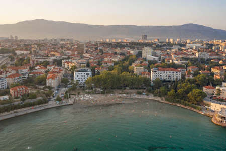 Split, Croatia - Aug 13, 2020: Aerial drone shot of Bavice city beach during sunset hour in summerのeditorial素材