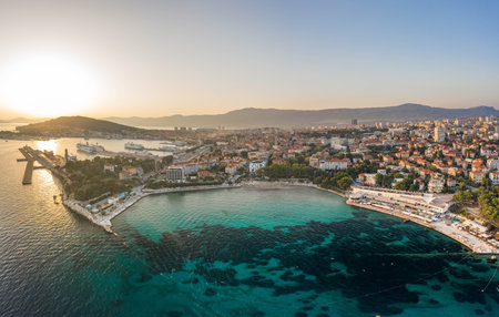 Split, Croatia - Aug 13, 2020: Aerial drone shot of Bavice city beach during sunset hour in summerのeditorial素材