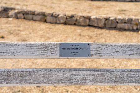 Vis, Croatia - Aug 19, 2020: Memorial name plate of royal air force on bench on top of vis island in...