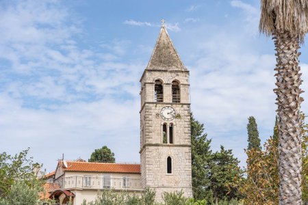 Vis, Croatia - Aug 18, 2020: Clock tower of St. Jeronima church at old town peninsulaのeditorial素材