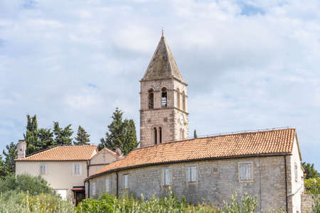 Vis, Croatia - Aug 18, 2020: Clock tower of St. Jeronima church at old town peninsulaのeditorial素材
