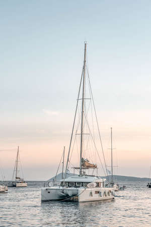 Catamaran float on Adriatic sea near Komiza Vis Island in Croatia sunset summerの写真素材
