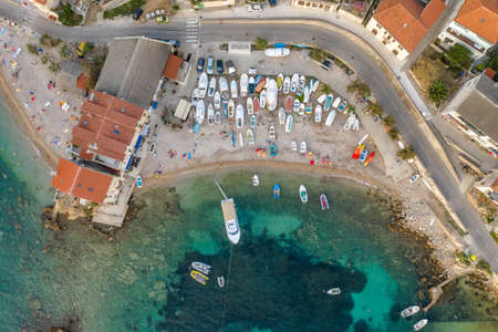 Aerial overhead done shot of Komiza town beach on Vis Island in Croatia sunset hourの写真素材