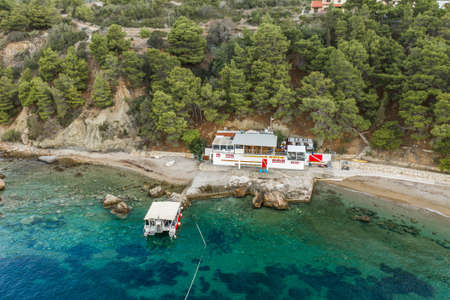 Komiza, Croatia - Aug 16, 2020: Aerial drone shot of boat rental at Gusarica beach on Vis Island before sunriseのeditorial素材