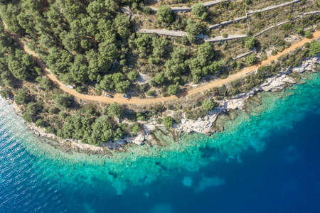 Aerial drone shot of road by Adriatic coastline on Vis Island in Croatia summer timeの写真素材