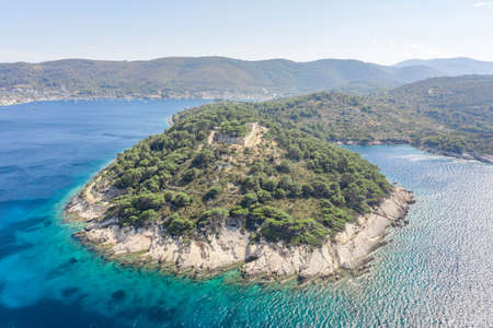 Aerial drone shot of stone Fort George Croatia on top of hill in Adriatic sea on Vis Island in summerの写真素材