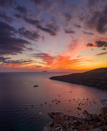Aerial drone shot of sunset burning sky clouds on Komiza town over Vis Island in Croatia Summerの写真素材