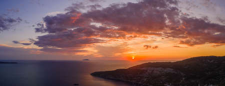 Aerial panoramic drone shot sunset over Adriatic horizon from Komiza town port on Vis Island in Croatia summerの写真素材