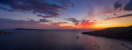 View of sunset burning sky clouds on Komiza town over Vis Island in Croatiaの写真素材