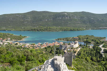 Mali Ston, Croatia - Aug 20, 2020: Narrow stone stairs down to seaside villageのeditorial素材