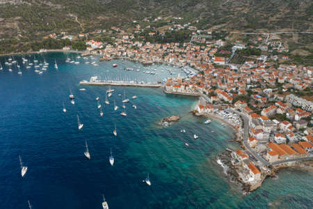 Aerial drone shot of Adriatic coastline dock by Komiza on Vis Island in morning before sunrise in Croatia summerの写真素材