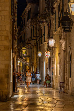 Dubrovnik, Croatia - Aug 20, 2020: Tourists without mask in street central town at night in pandemic summerのeditorial素材