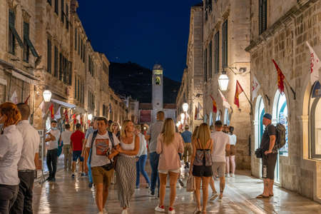 Dubrovnik, Croatia - Aug 20, 2020: Tourists without mask in main street central town at night in pandemic summerのeditorial素材