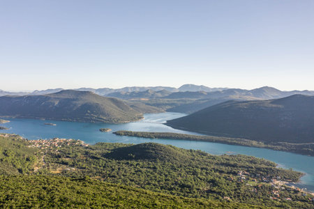 Aerial drone shot of City Wall of Ston over hill to Mali Ston in Croatia summer morning sunrise