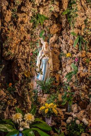 Dubrovnik, Croatia - Aug 20, 2020: Virgin Mary setup surrounded by flowers lime stone in St. Ignatius churchのeditorial素材