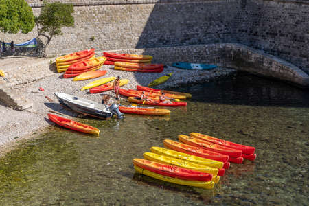 Dubrovnik, Croatia - Aug 20, 2020: Tourists kayak in Adriatic sea below Bokar Fortressのeditorial素材