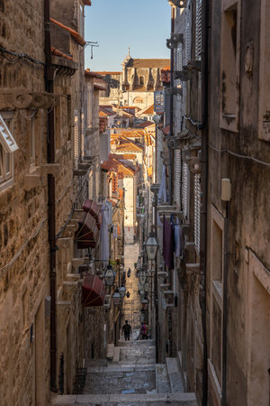 Dubrovnik, Croatia - Aug 22, 2020: Narrow stone stairway to old town with view of St. Blaise church in summer morningのeditorial素材