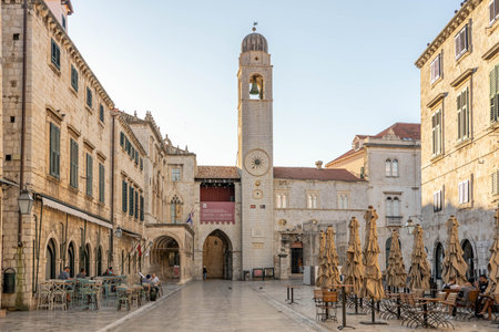 Dubrovnik, Croatia - Aug 22, 2020: Bell tower view from empty stradun street in old town morning sunriseのeditorial素材
