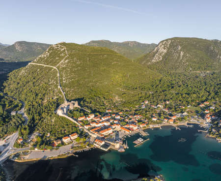 Aerial drone shot of Mali Ston village with City Wall of Ston in Ragusa near Dubrovnik in Croatia summer sunriseの写真素材