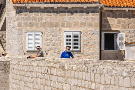Dubrovnik, Croatia - Aug 22, 2020: Tourists wear mask on city wall St. Margaret fort in summerのeditorial素材