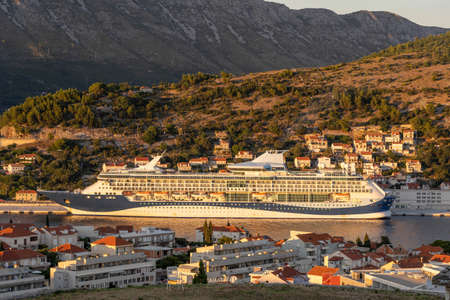 Enormous cruise at Dubrovnik port in sunset in Croatia summerの写真素材