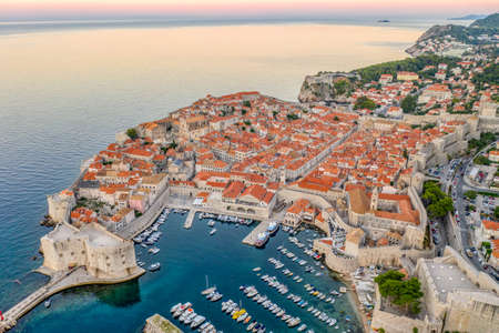 Aerial drone shot of Dubrovnik old town port with pink sky before sunrise in Dubronik summer morningの写真素材