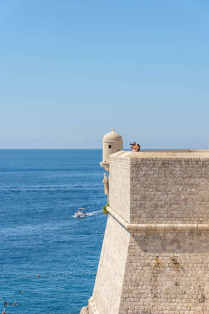 Dubrovnik, Croatia - Aug 22, 2020: Tourists on top of Fort St. Margaret city wall in old town in summerのeditorial素材