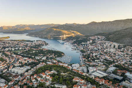 Aerial drone shot of Lapad Dubrovnik bridge with sunrise over peak in Croatia summer morningの写真素材