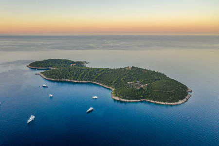 Aerial drone shot of Otok Lokrum in Adriatic sea by Dubrovnik old town port in Croatia summer before sunriseの写真素材