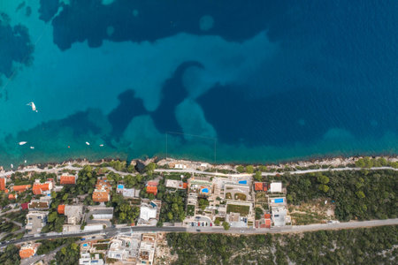 Aerial overhead drone shot of sunset beach in Dubrovnik by Dalmatia coastline in Croatia summer