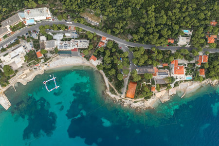 Aerial overhead drone shot of sunset beach in Dubrovnik by Dalmatia coastline in Croatia summer