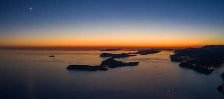 Aerial panorama drone shot of sunset horizon in Adriatic islands in Dubrovnik in Croatia summerの写真素材