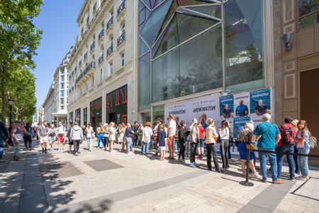 Paris, France - June 27, 2022: People queuing outside Stranger Things Pop-Up store on avenue Champs...