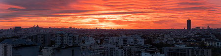 Panoramic view of Paris skyline with sacre coeur in morning red sky with dramatic cloudsの写真素材