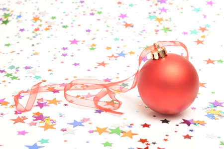 Christmas bauble on star shaped confettiの写真素材