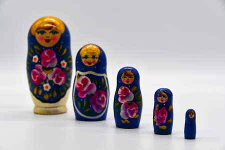 Classic Russian matryoshkas in row on put with white backgroundの写真素材
