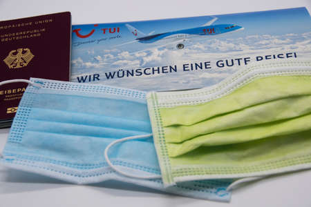 RHEINBACH, GERMANY July 29, 2020 Travel documents from TUI with German passport and respiratory masksのeditorial素材