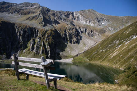 Wooden bench with a view of the "Seebachsee"の写真素材