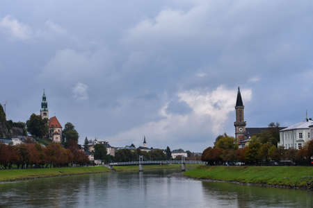 The view from the Makartsteg in Salzburg to the Mullner Church and the Salzburg Christ Church in cloudy weatherのeditorial素材