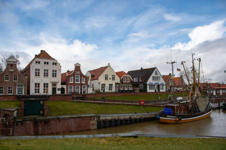 The view of the old traditional houses in the harbor of Greetsielのeditorial素材