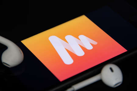 Rheinbach, Germany 4 May 2021, Close-up of the "Musi" logo on the screen of a smartphone with headphonesのeditorial素材