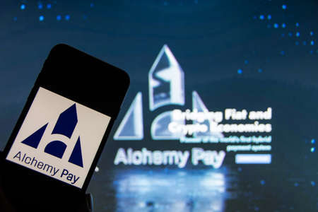Rheinbach, Germany 13 January 2022, The logo of the cryptocurrency "Alchemy Pay" on the display of a smartphone in front of the website (focus on logo)のeditorial素材