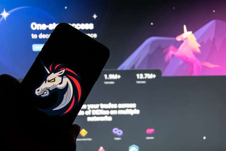 Rheinbach, Germany 15 February 2022, The logo of the cryptocurrency "1inch" on the display of a smartphone in front of the website (focus on the logo)のeditorial素材