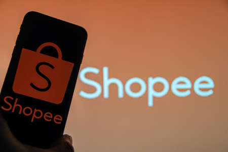 Rheinbach, Germany 25 March 2022, The brand logo of the Ecomerce company "Shopee" on the display of a smartphone (focus on the brand logo)のeditorial素材