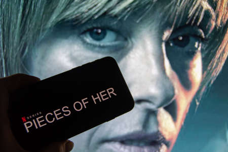 Rheinbach, Germany March 25, 2022, The logo of the new Netflix series "Pieces of her" on the display of a smartphone in front of the TVのeditorial素材