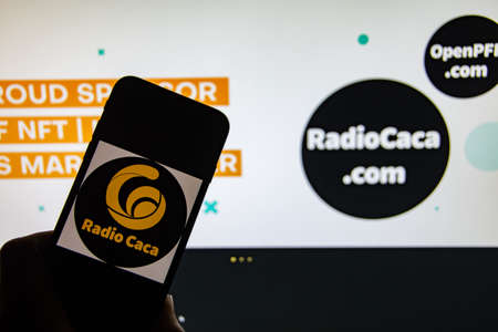 Rheinbach, Germany April 1, 2022, The logo of the cryptocurrency "Radio Caca" on the display of a smartphone in front of the website (focus on the logo)のeditorial素材
