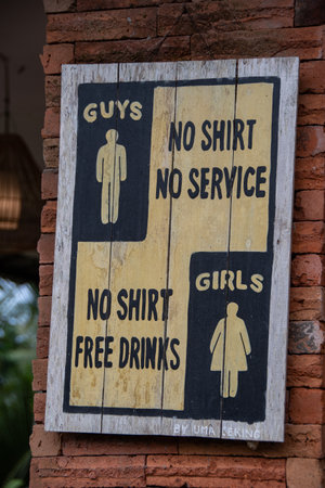 Bali, Indonesia September 1, 2022, Funny Sign Saying "Guys No Shirt No Service" and "Girls No Shirt Free Drinks"のeditorial素材